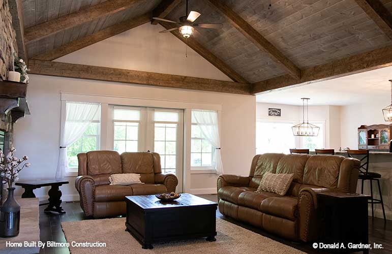 Vaulted ceiling with wood beams in the great room. The Simon plan 1351.