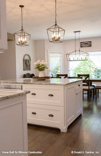 Hanging lighting above the island in the kitchen. The Simon plan 1351.