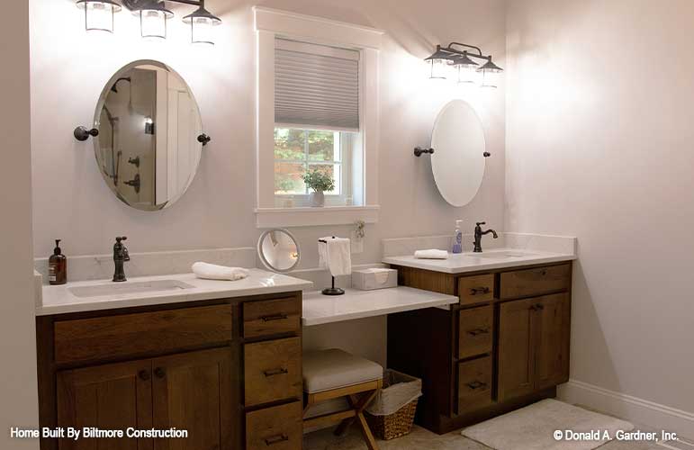 Two separate vanities with a window between in the master bathroom. The Simon plan 1351.