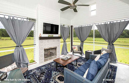 Cozy screened in porch with outdoor fireplace. Sloan plan 1528