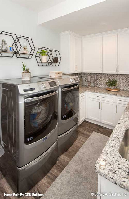 Utility room with laundry are and lots of counter space and cabinets. Sloan plan 1528