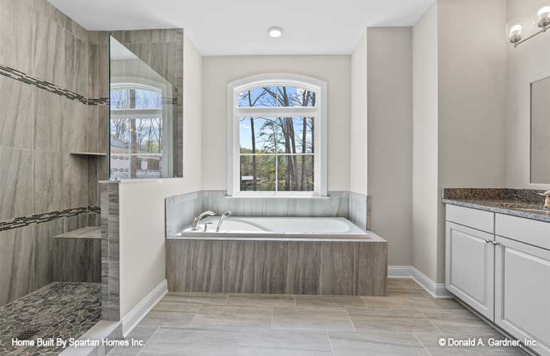 This is a master bathroom picture with tub of walkout basement house plan 1143 The Somersby