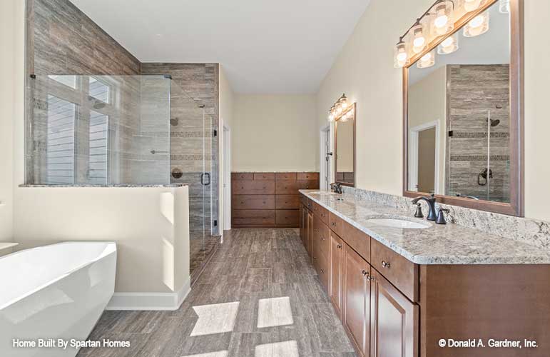 This is a picture showing vanity and bathroom of luxury house plan 876 The Steeplechase