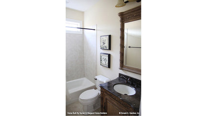 Single sink vanity and tub in the bathroom. The Summerhill plan 1090.