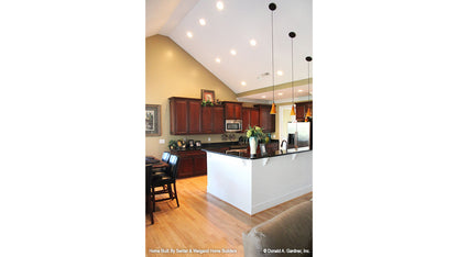 Hanging pendant lights over the bar in the kitchen. The Summerhill plan 1090.