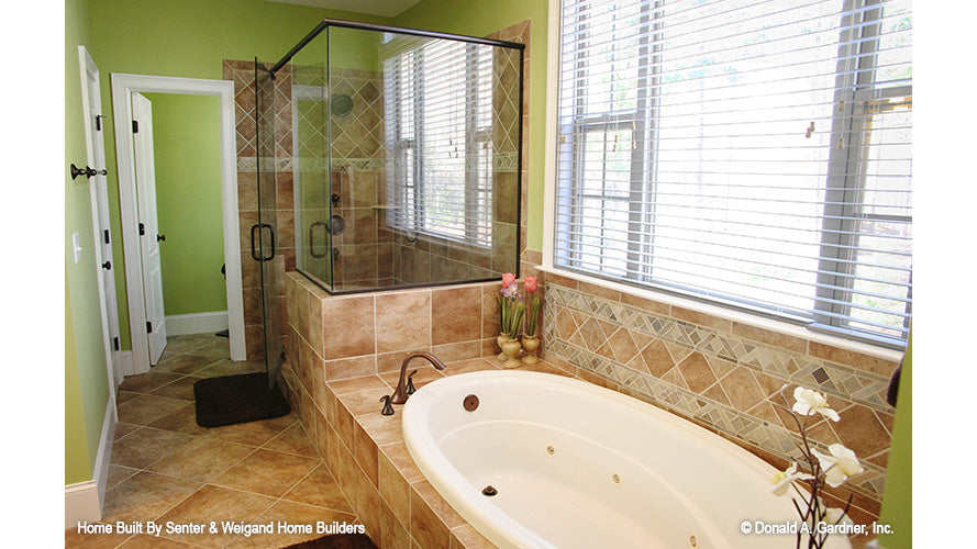 Soaking tub next to the walk-in shower in the master bathroom. The Summerhill plan 1090.