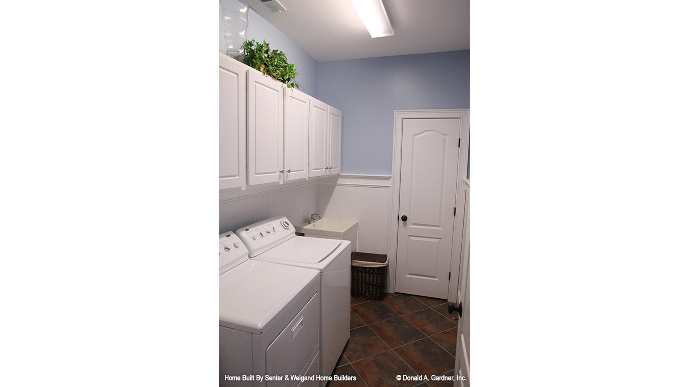 Cabinets and sink in the utility room. The Summerhill plan 1090.