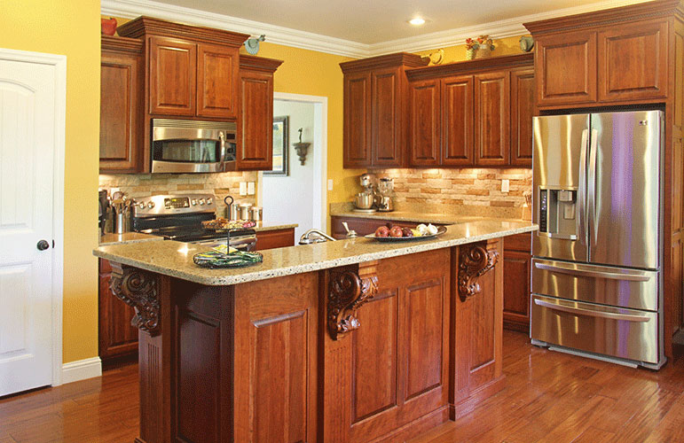 Kitchen island with wood stained panels. The Swansboro plan 853.