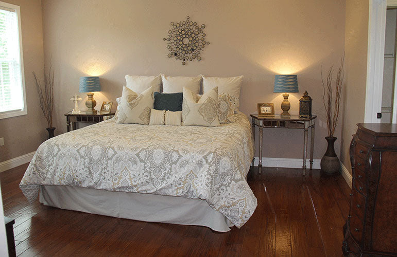 Cozy master bedroom with wood floors. The Swansboro plan 853.