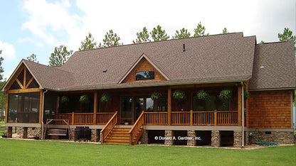 Rear view photograph of a cedar craftsman style with a screened in porch.  The Sycamore Hall plan 5000.