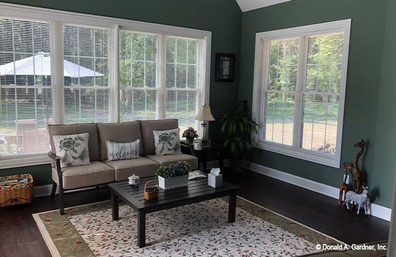 The screened porch turned into a sun room adds to the living spaces of of The Sydney plan 1438