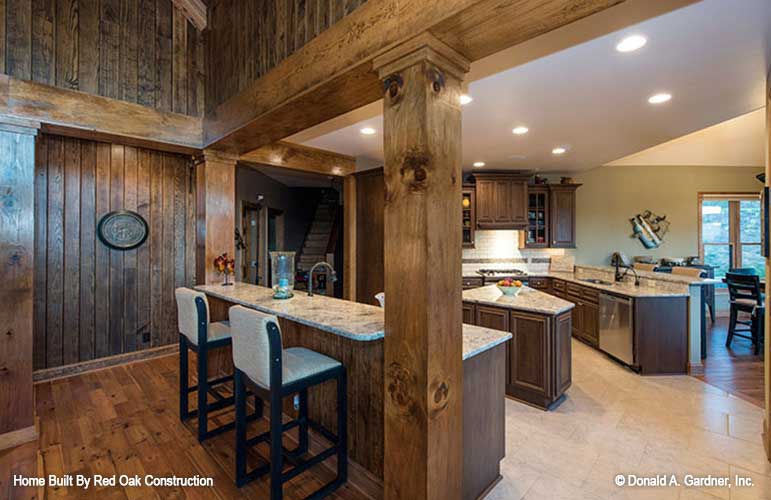 Stained wood cabinets in the kitchen. The Sylvan plan 1321.