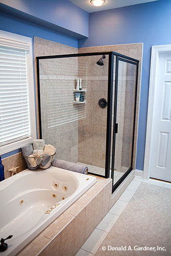 Soaking tub beside the walk-in shower in the master bathroom. The Tamassee plan 333.