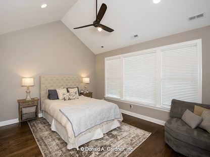 Master bedroom with vaulted ceiling and large windows