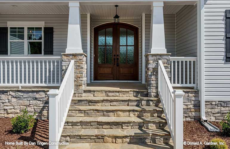 Gorgeous stone work on steps leading to the front porch and door. Tanner plan 1418