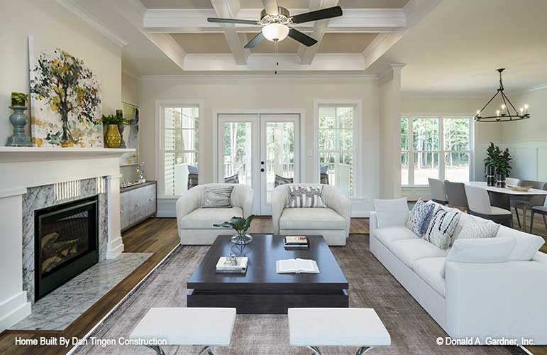 Elegant great room displaying fireplace and coffered ceiling, rear view to the patio doors. Tanner plan 1418