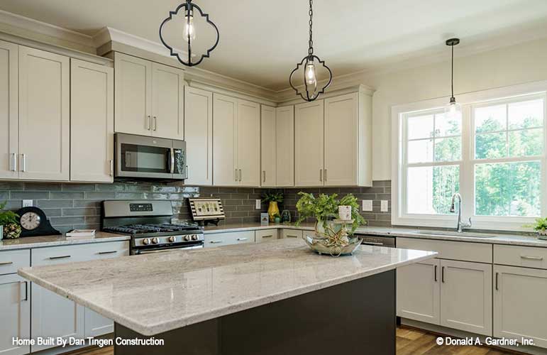 Island view of the kitchen, natural light from the double windows above the sink. Tanner plan 1418