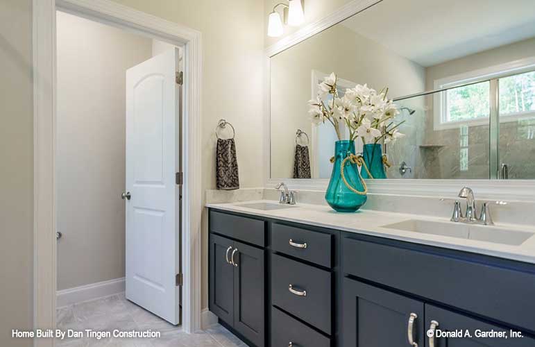 Classy master bathroom with double sink vanity and toilet room off to the side. Tanner plan 1418