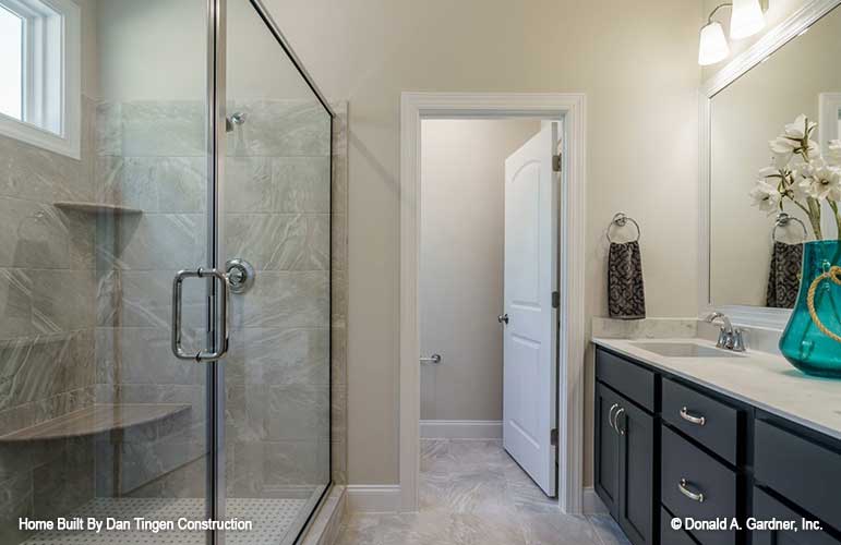 Isle view of the bathroom with the vanity and shower off to either side leading to the toilet room. Tanner plan 1418