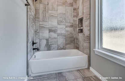 Tiled shower/ tub wall in the bathroom. Thurman plan 1515