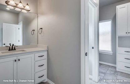 Single sink vanity with linen storage off to the side in the bathroom. Thurman plan 1515