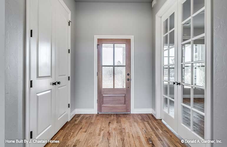 Foyer with French doors on either side of the foyer hall. Thurman plan 1515