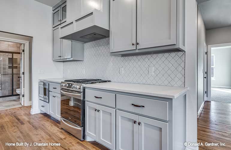 Backsplash tile work along the wall with the stove in the kitchen. Thurman plan 1515