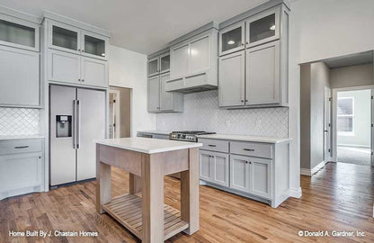 Kitchen view of the stainless-steel stove and fridge. Thurman plan 1515