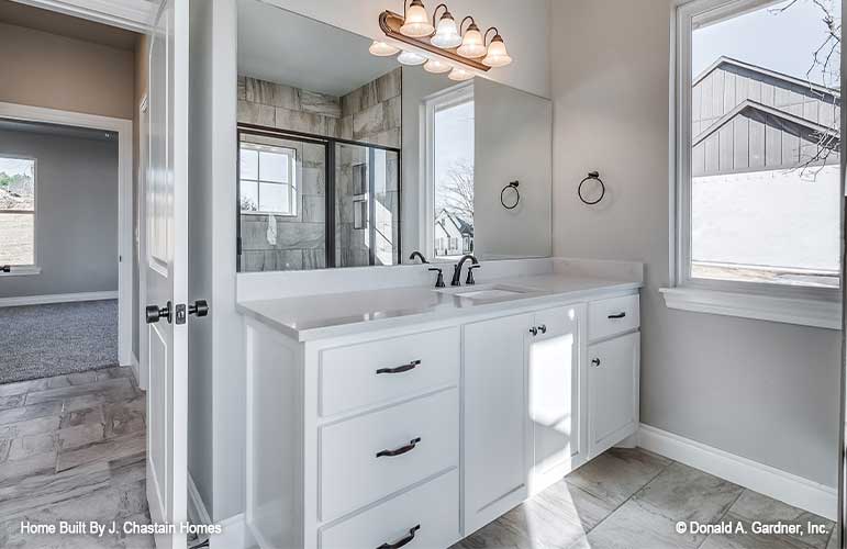 Single vanity beside large window in the master bathroom. Thurman plan 1515