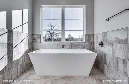 Gorgeous stand-alone soaking tub with window above in the master bathroom. Thurman plan 1515