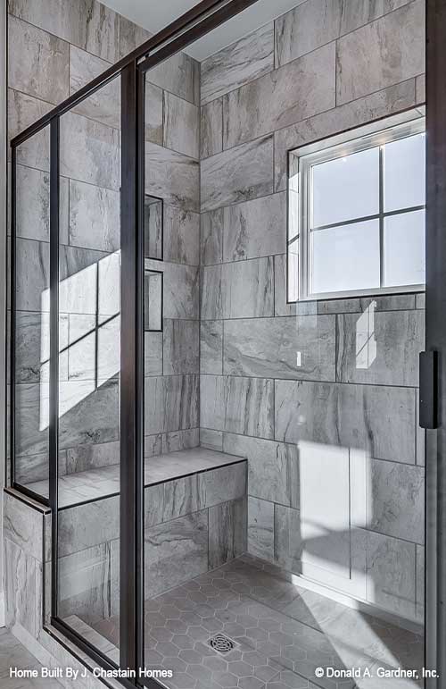 Walk-in shower with sitting bench in master bathroom. Thurman plan 1515