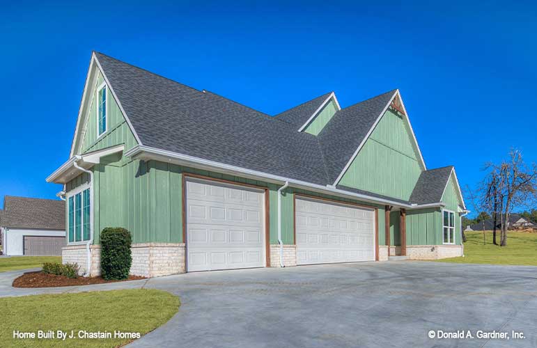 Side view with three car garage photograph of the Thurman plan 1515. 