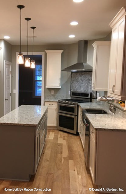 Recessed lighting and pendant lighting in the kitchen. The Topeka plan 1000.