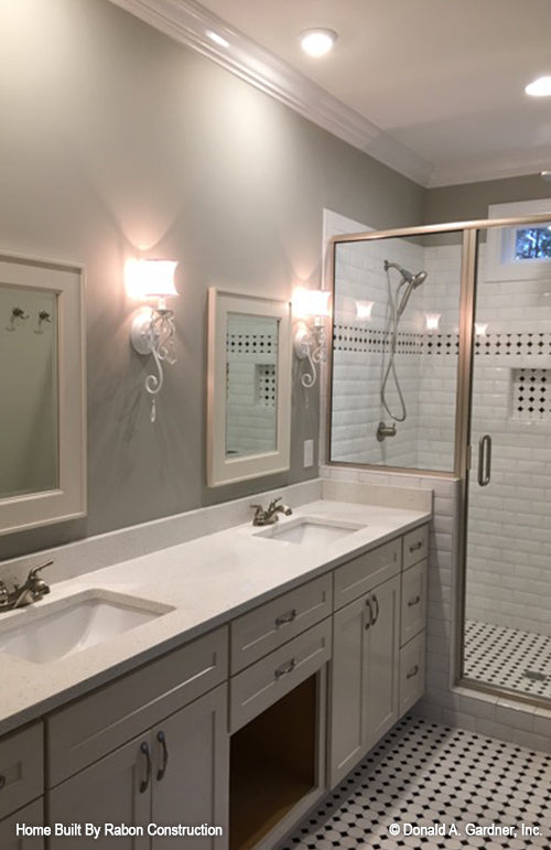 Double sink vanity and walk-in shower in the master bathroom. The Topeka plan 1000.