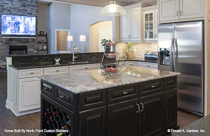 Island with cabinets in the kitchen. The Travis plan 1350.