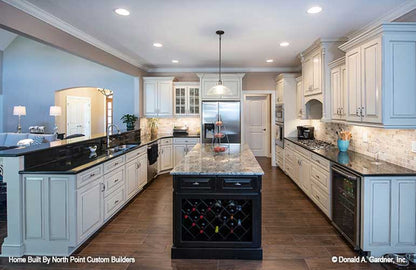 Full view of the kitchen with white cabinets. The Travis plan 1350.