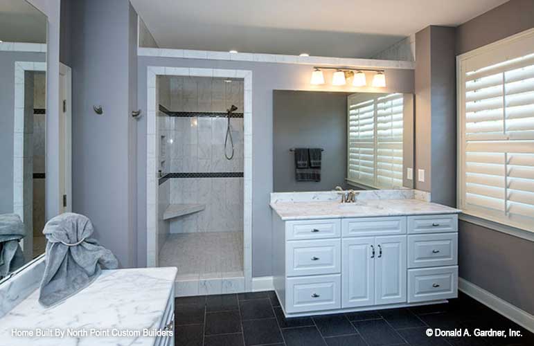 Single sink vanity in front of the walk-in shower in the master bathroom. The Travis plan 1350.