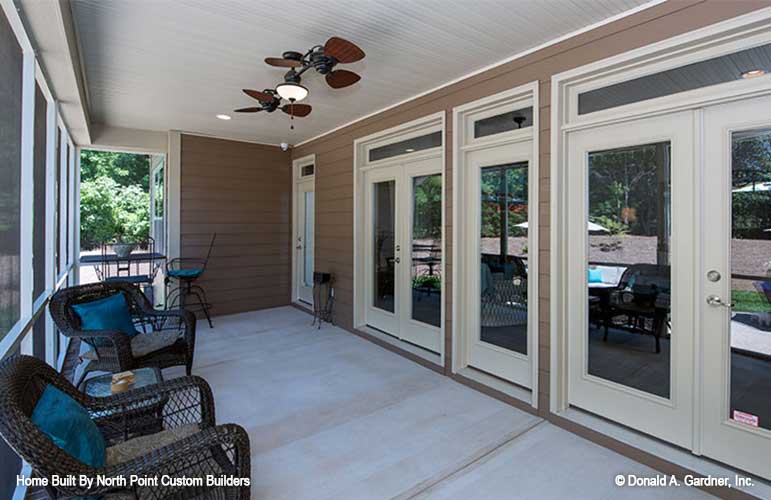 Screened porch with three access doors to inside the home. The Travis plan 1350.