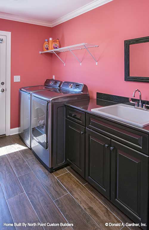 Sink and cabinets in the utility room. The Travis plan 1350.