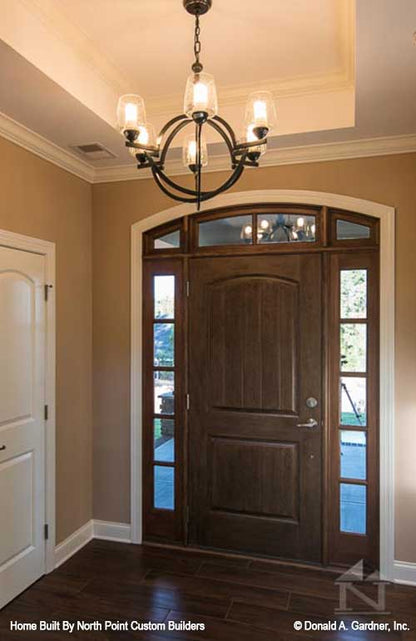 Tray ceiling and chandelier in the foyer. The Travis plan 1350.