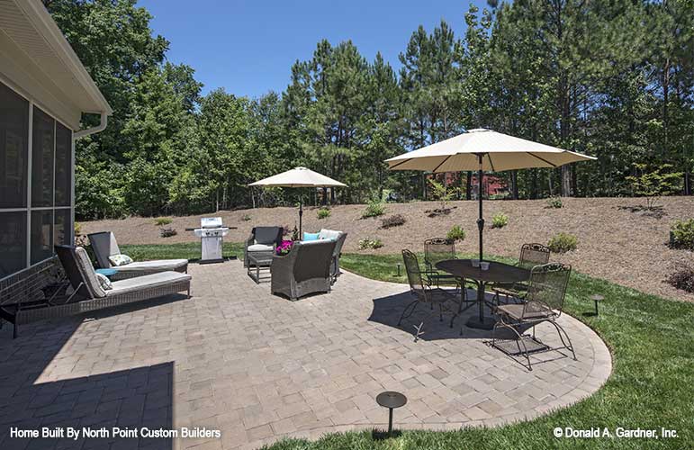 Stone patio on the rear of the house. The Travis plan 1350.