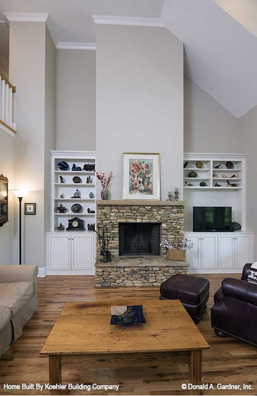 Stone fire place and mantel with built in shelves in the great room. The Tristan plan 1311.