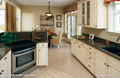 White cabinets in the kitchen. The Trotterville plan 984.