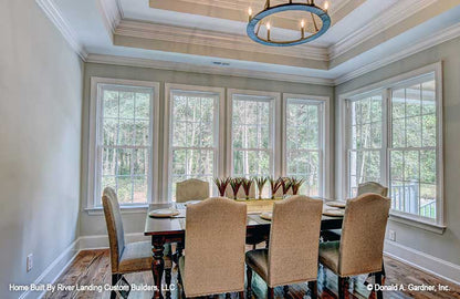 An open dining room gives space for both formal and casual dining for one story house plan 1341 The Tucker