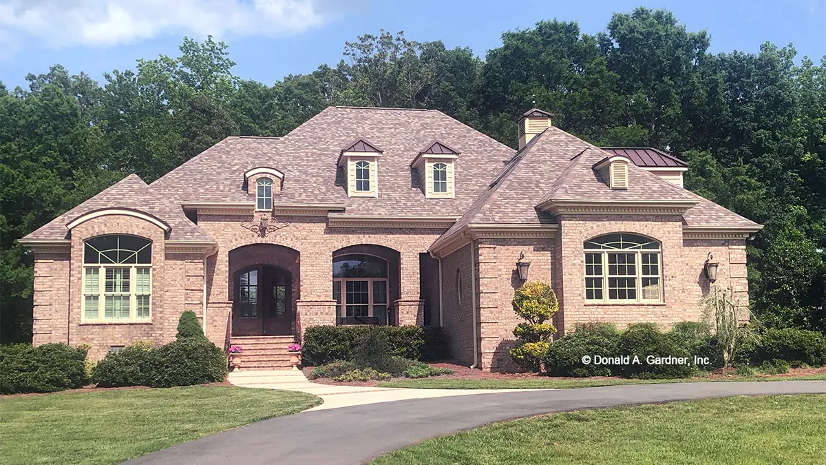 This is a photograph of the front of French Country house plan 1186 The Verdelais as built by a customer