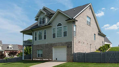 This is a photograph of the rear of two story house plan 1063 The Vissage as built by a customer