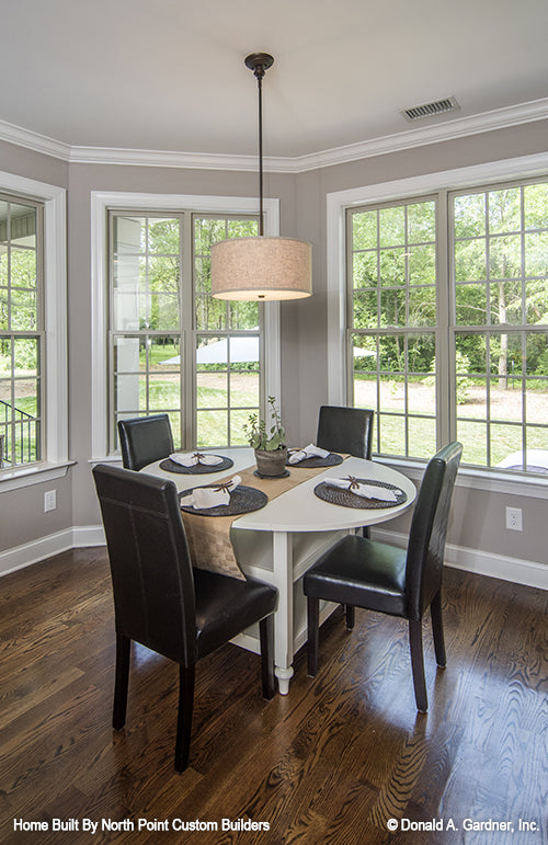 Crown molding ceiling and surrounding windows in the dining room. The Weatherford plan 1053.