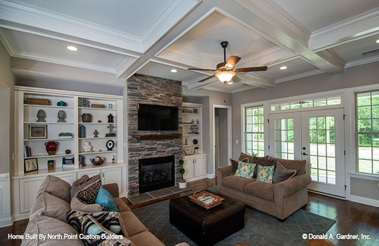 Built in shelves and stone fireplace in the great room. The Weatherford plan 1053.