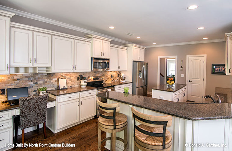 Recessed lighting on the flat ceiling in the kitchen. The Weatherford plan 1053.