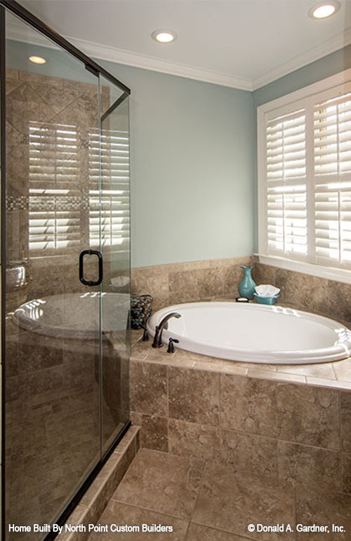 Corner sitting tub beside the walk-in shower. The Weatherford plan 1053.